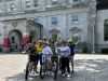 A family has joined Ottawa Electric Bike Tour with Escape in Ottawa and are taking a picture with Escape Guide at Rideau Hall